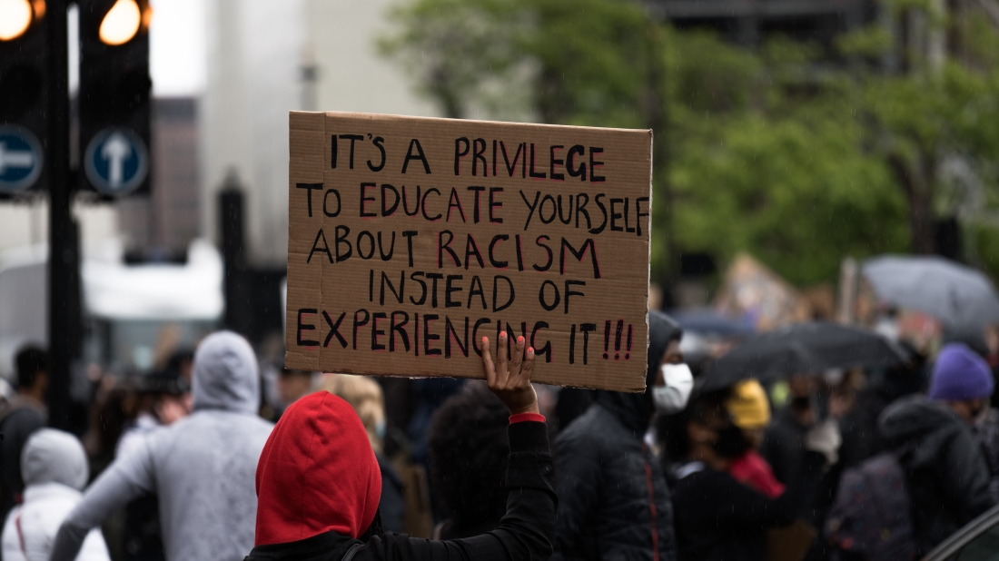 Man holding sign to end racism